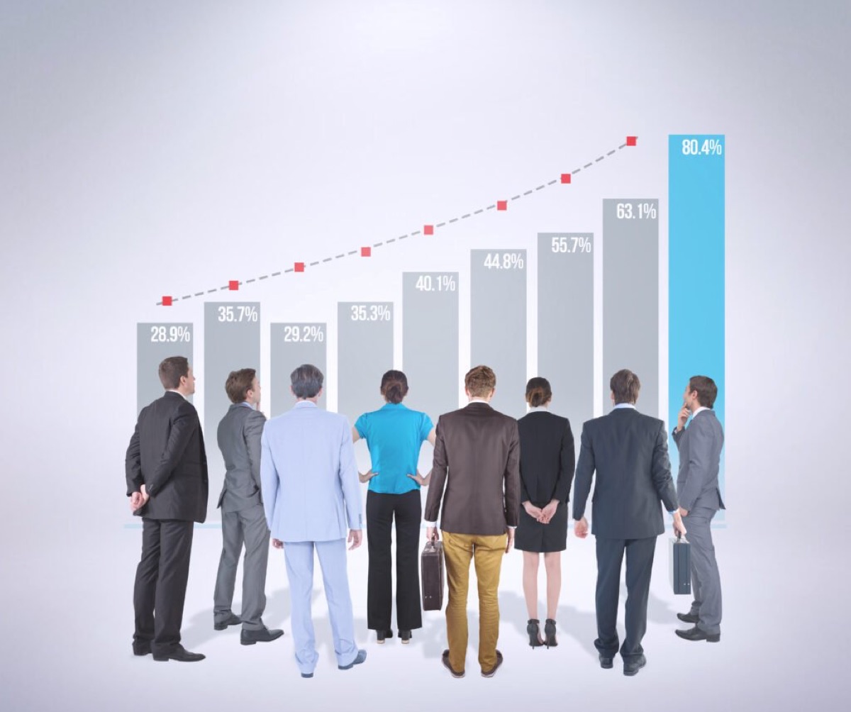 A business team standing together against a grey background